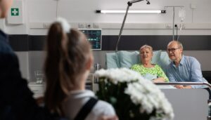 A young girl is bringing flowers to her grandmother who is in the hospital.